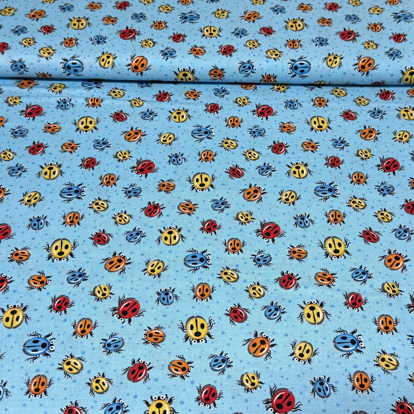 Playful Ladybug Toss Quilting Fabric – Blue Background | 100% Cotton | 45” Wide